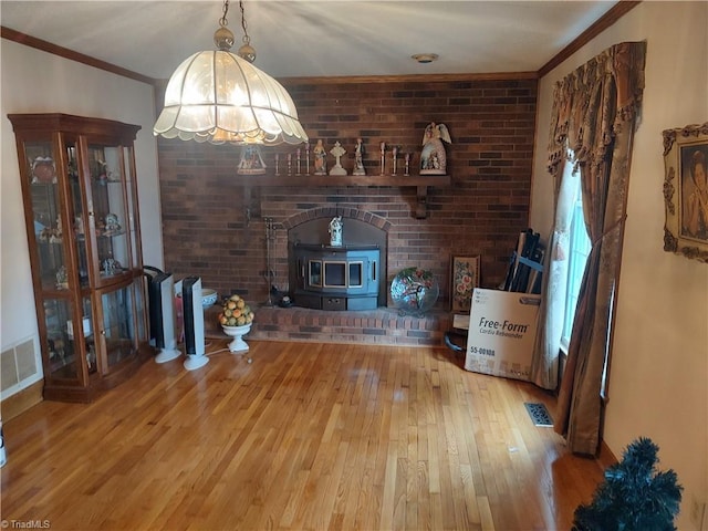 345 Anderson Rd, Eden, NC 27288 - unfurnished living room with hardwood / wood-style floors, brick wall, ornamental molding, and visible vents