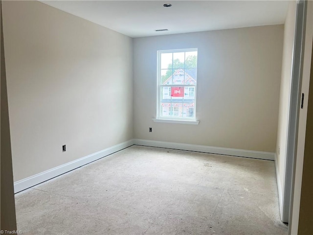 empty room featuring visible vents and baseboards