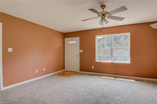 261 Williamsgate Ct, Winston-Salem, NC 27107 - empty room featuring a textured ceiling, carpet, baseboards, and a ceiling fan