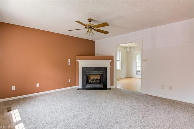 261 Williamsgate Ct, Winston-Salem, NC 27107 - unfurnished living room with ceiling fan, carpet flooring, a chandelier, a fireplace with flush hearth, and a textured ceiling