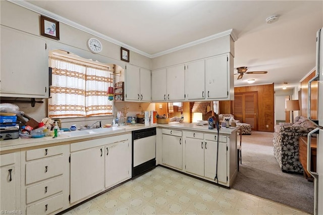 kitchen with light floors, ornamental molding, a sink, light countertops, and dishwasher