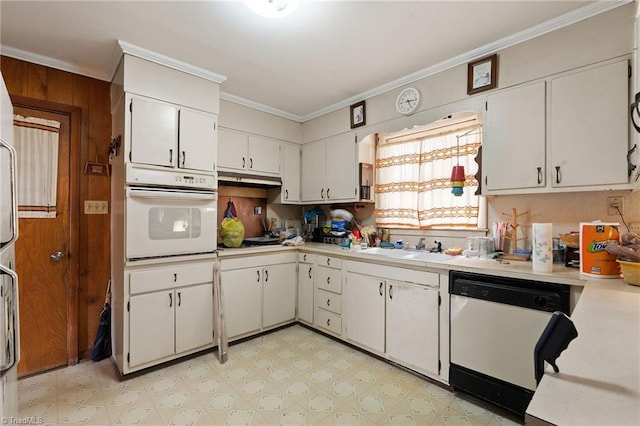 kitchen featuring white appliances, light floors, a sink, ornamental molding, and light countertops