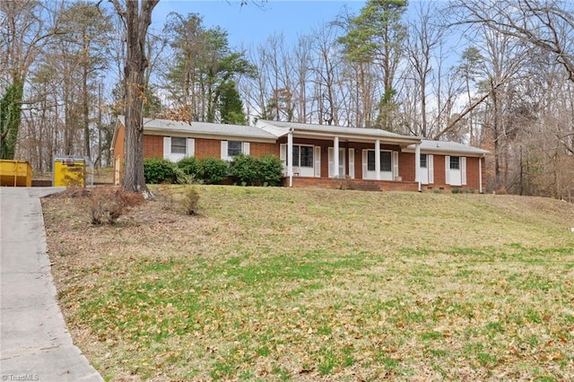 ranch-style home with a front lawn, a porch, and brick siding