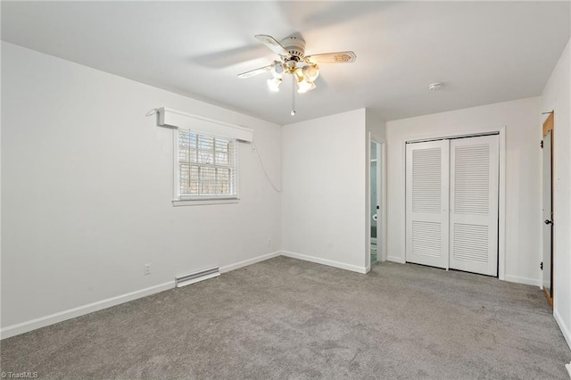 unfurnished bedroom with a closet, visible vents, carpet flooring, and baseboards