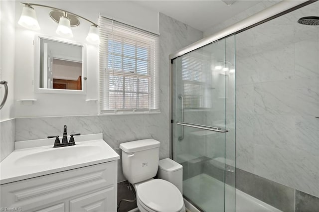 bathroom with vanity, toilet, and a stall shower