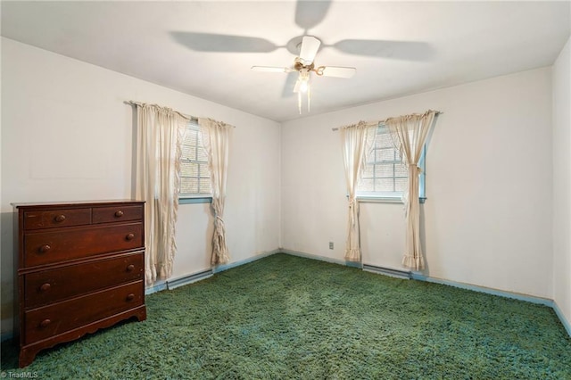 unfurnished room with plenty of natural light, carpet flooring, baseboards, and a ceiling fan