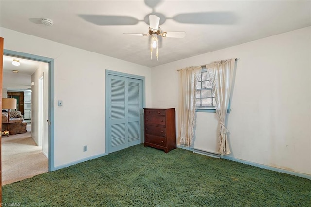 unfurnished bedroom with a closet, carpet flooring, ceiling fan, and baseboards