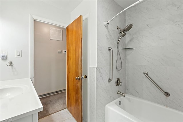 bathroom with tub / shower combination, visible vents, and vanity