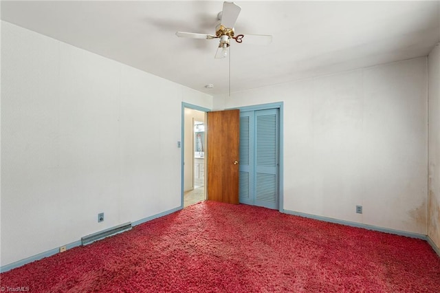 empty room featuring baseboards, visible vents, a ceiling fan, and carpet