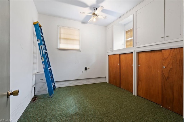 unfurnished bedroom featuring two closets, carpet, and ceiling fan