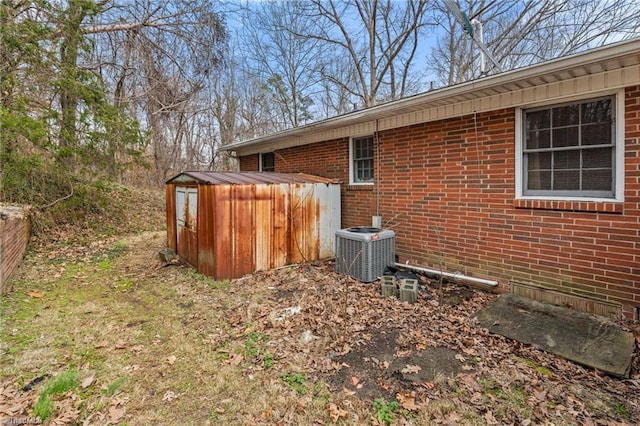 view of property exterior featuring central air condition unit and brick siding