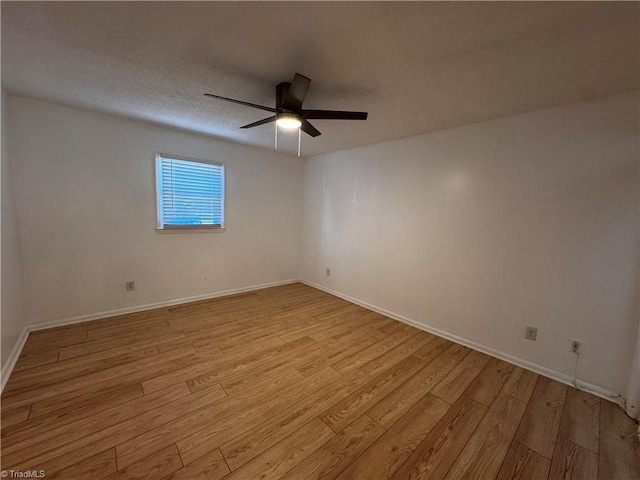 empty room featuring light wood-type flooring and ceiling fan