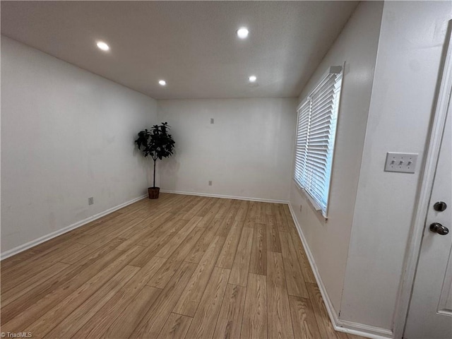 unfurnished room with light wood-type flooring