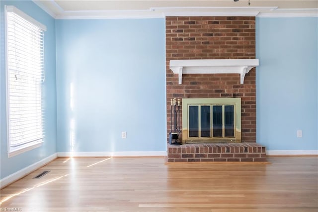 unfurnished living room with ornamental molding, a fireplace, and light wood-type flooring