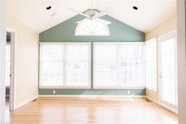 unfurnished sunroom with vaulted ceiling, a healthy amount of sunlight, and ceiling fan