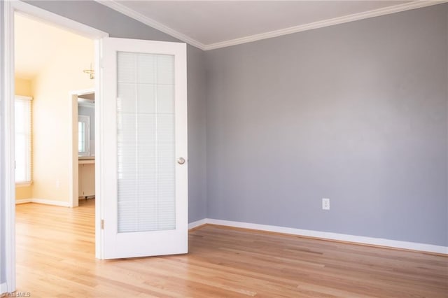 spare room featuring crown molding and light wood-type flooring