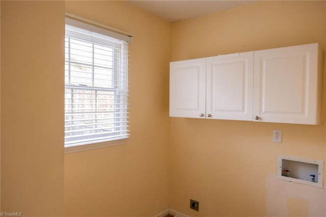 washroom with cabinets, hookup for a washing machine, and hookup for an electric dryer