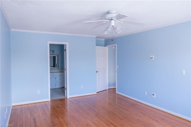 spare room with hardwood / wood-style flooring, ceiling fan, and ornamental molding