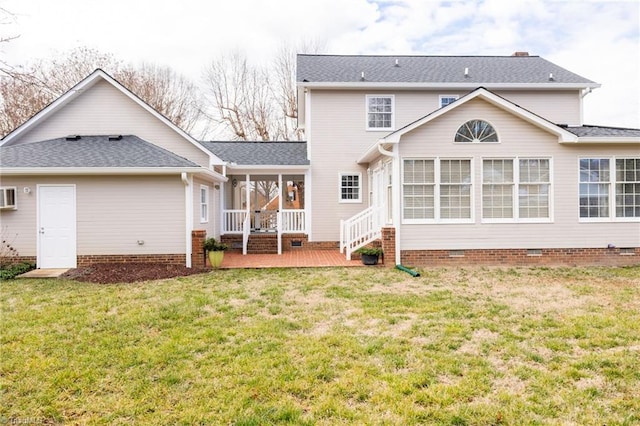 back of property featuring a sunroom, a yard, and a deck