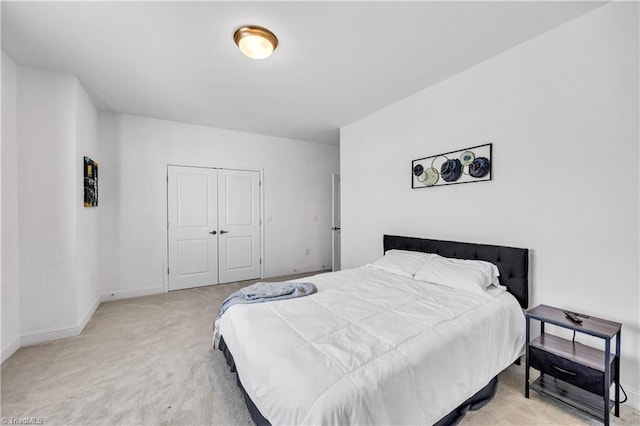 bedroom with a closet and light colored carpet