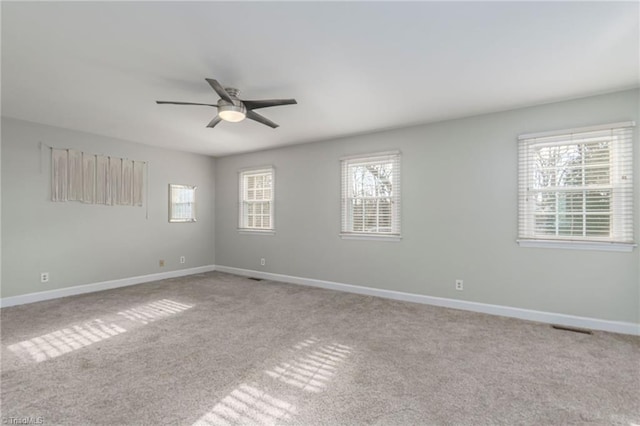 carpeted spare room with ceiling fan