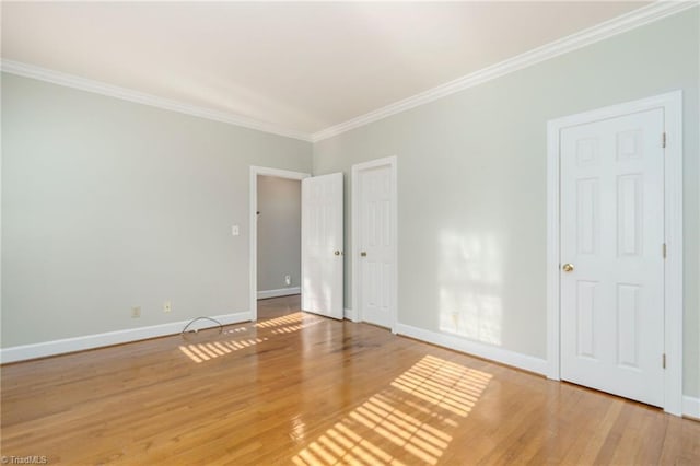 unfurnished room with wood-type flooring and crown molding