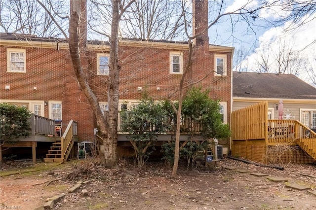 back of property with central AC unit and a deck