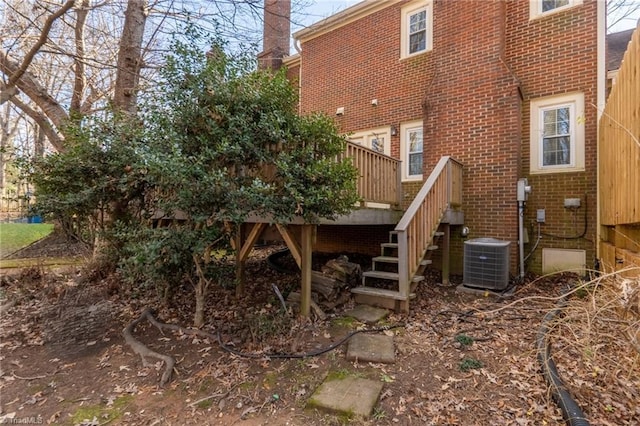 back of house featuring cooling unit and a deck