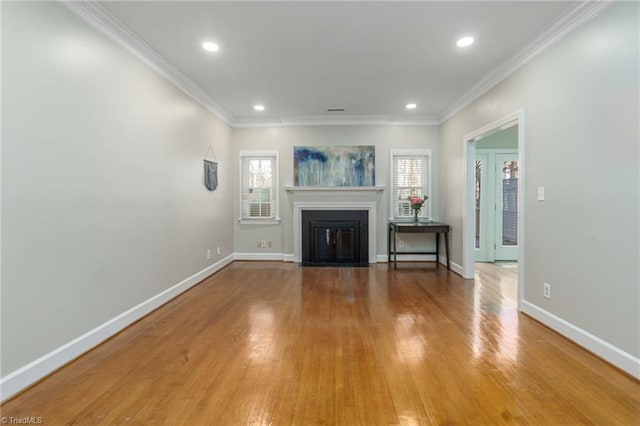 unfurnished living room featuring light hardwood / wood-style flooring and ornamental molding