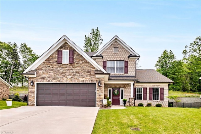 craftsman inspired home featuring concrete driveway, a front yard, a garage, and fence