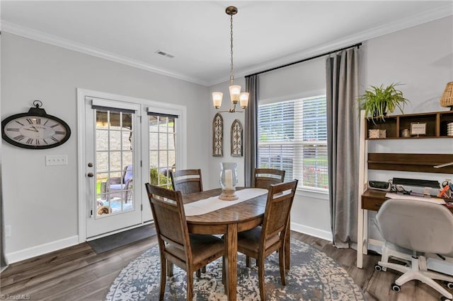 dining space with dark wood-style flooring, visible vents, crown molding, and baseboards