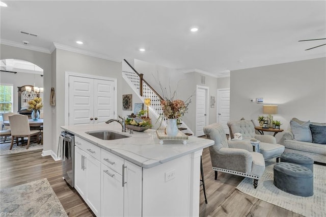 kitchen featuring white cabinetry, a sink, open floor plan, dishwasher, and recessed lighting