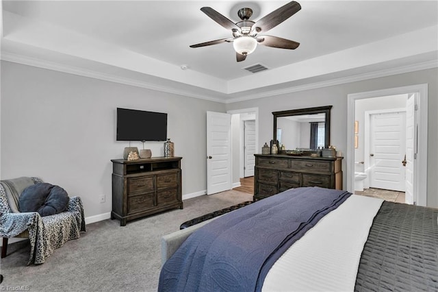 bedroom with a tray ceiling, visible vents, carpet, baseboards, and ornamental molding