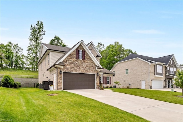 view of front of house with a front yard, driveway, stone siding, an attached garage, and fence