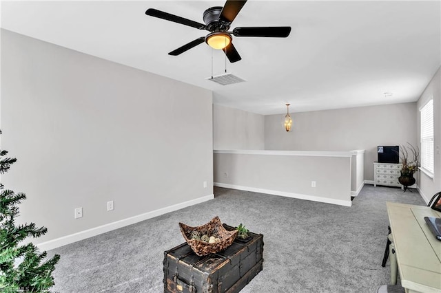 living area with visible vents, ceiling fan, carpet flooring, and baseboards