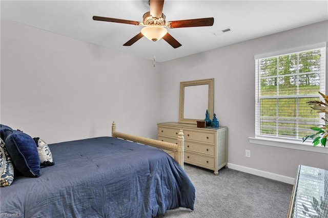 bedroom featuring light colored carpet, visible vents, multiple windows, and baseboards