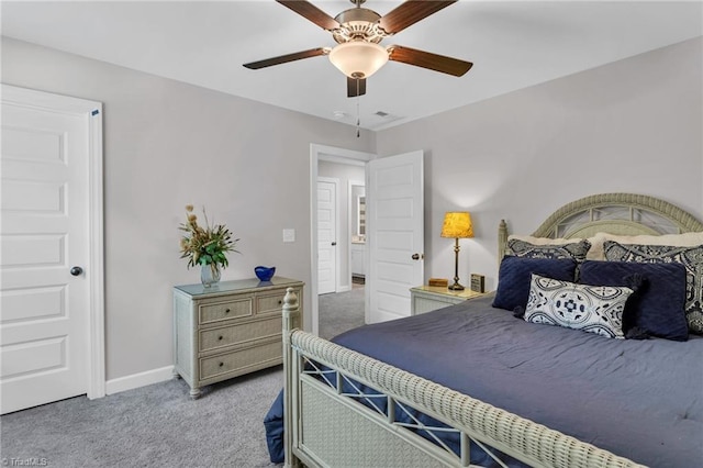 bedroom featuring baseboards, visible vents, light carpet, and ceiling fan