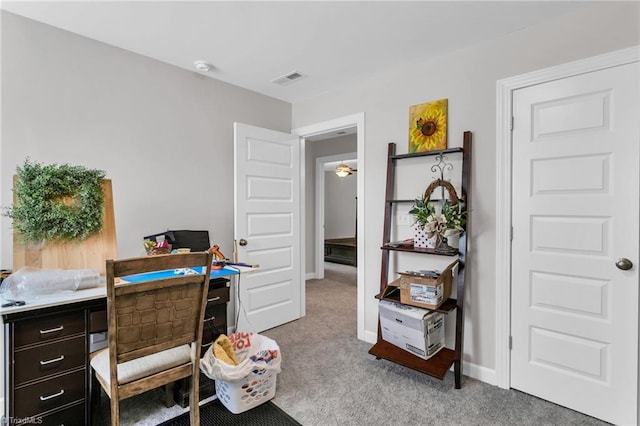 home office featuring baseboards, visible vents, and light carpet