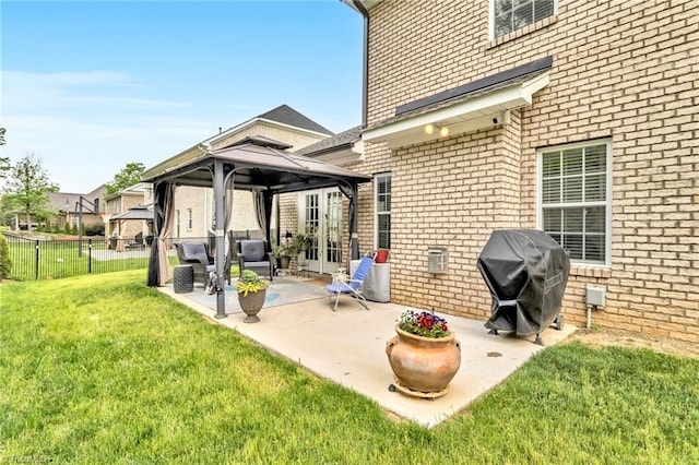 view of patio featuring fence, a gazebo, and a grill