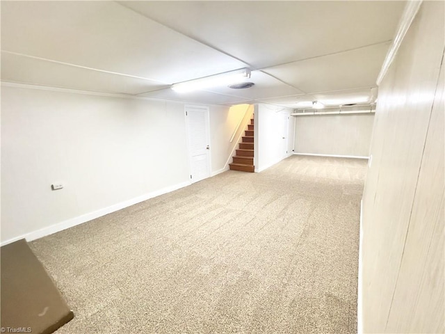 basement featuring crown molding and light carpet