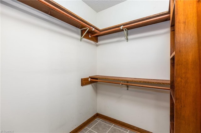 walk in closet with tile patterned flooring