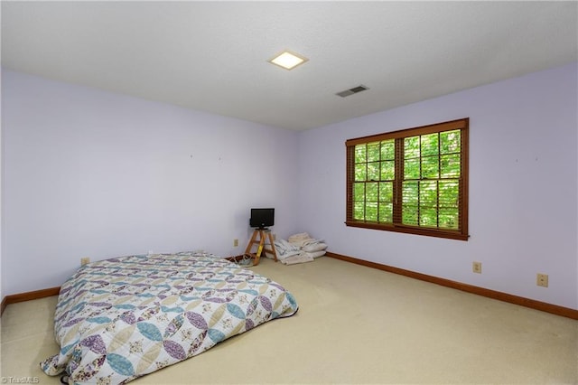 carpeted bedroom featuring baseboards