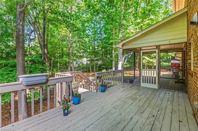 wooden deck featuring a sunroom
