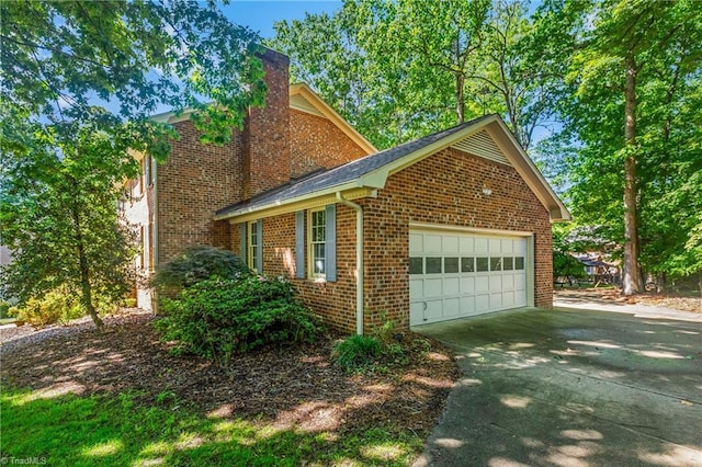 view of home's exterior with brick siding and a chimney
