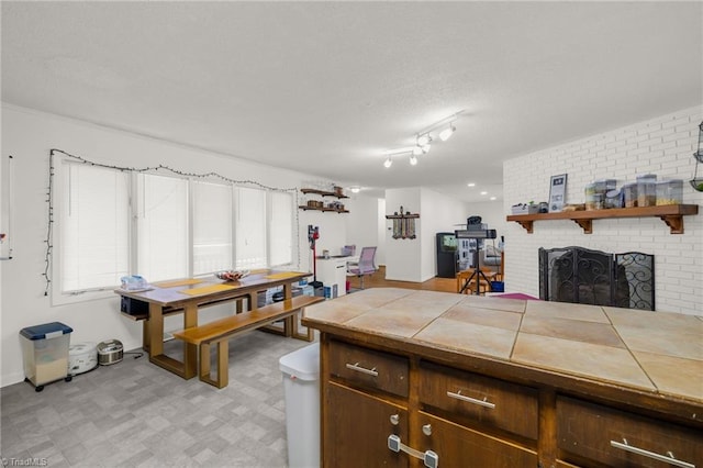 kitchen featuring tile counters and a fireplace