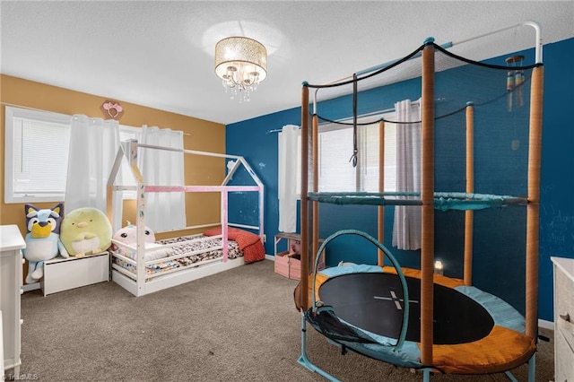 bedroom featuring a notable chandelier and carpet