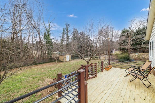 wooden deck featuring a storage shed and a yard