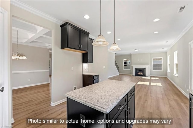 kitchen with recessed lighting, ornamental molding, light wood finished floors, and visible vents