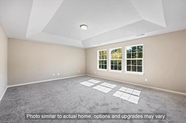 unfurnished room featuring carpet floors, a raised ceiling, baseboards, and visible vents