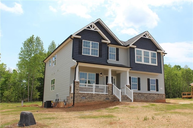 craftsman house with central AC unit, a front yard, a porch, and crawl space